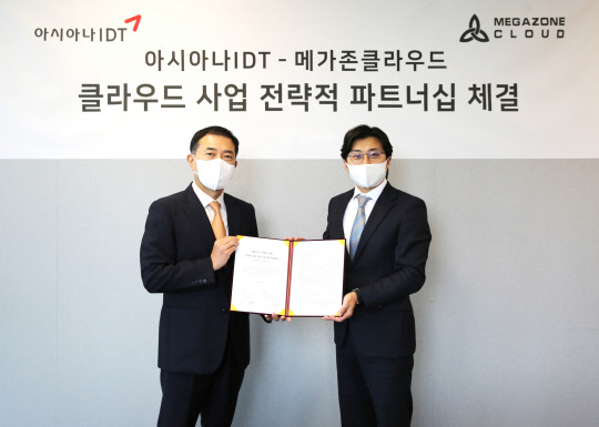 서근식(왼쪽) 아시아나IDT 대표와 이주완 메가존클라우드 대표가 사업협약을 맺은 후 사진을 찍고 있다.  메가존클라우드 제공